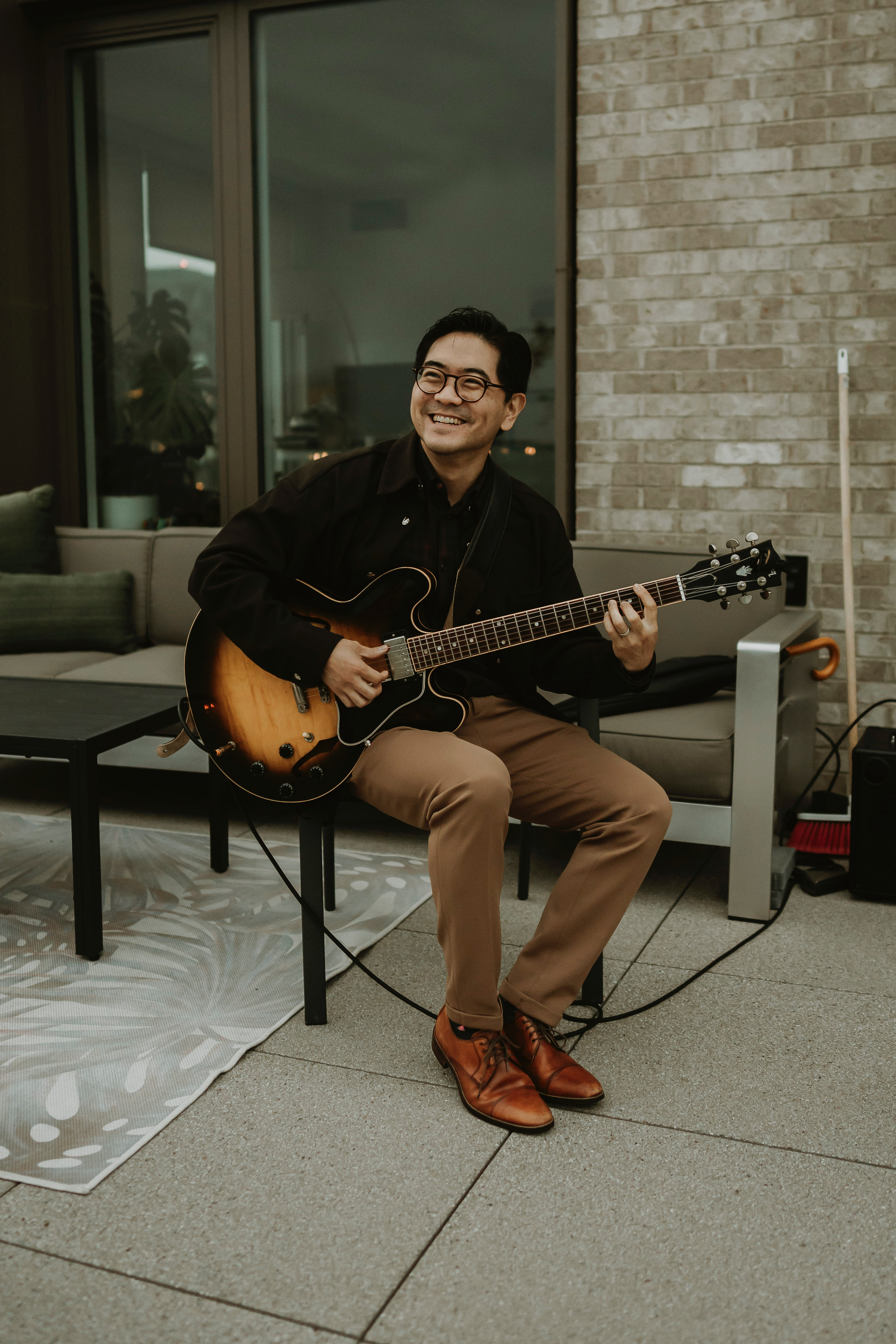 Tony Song smiling with guitar