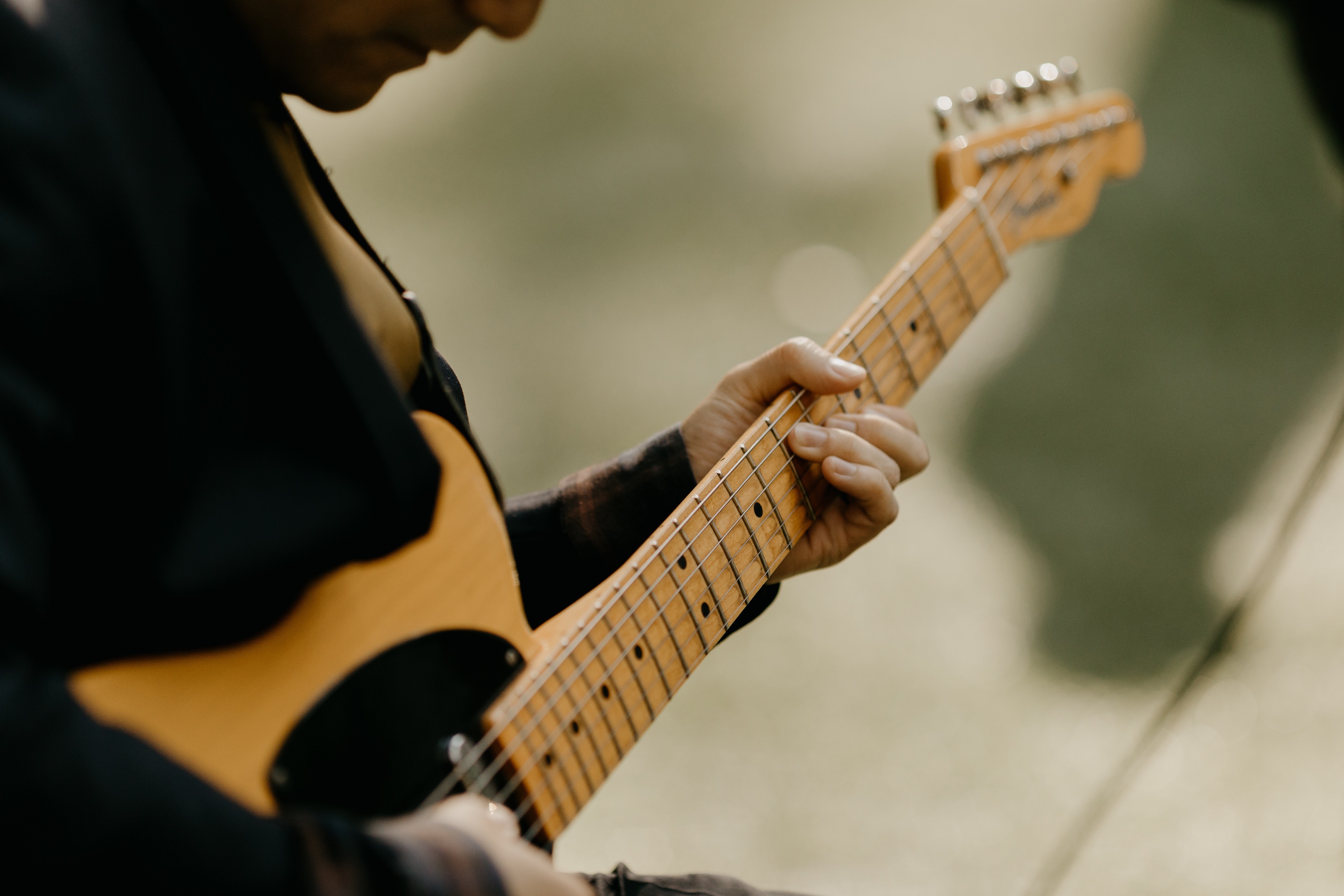 Close-up of Tony Song playing guitar