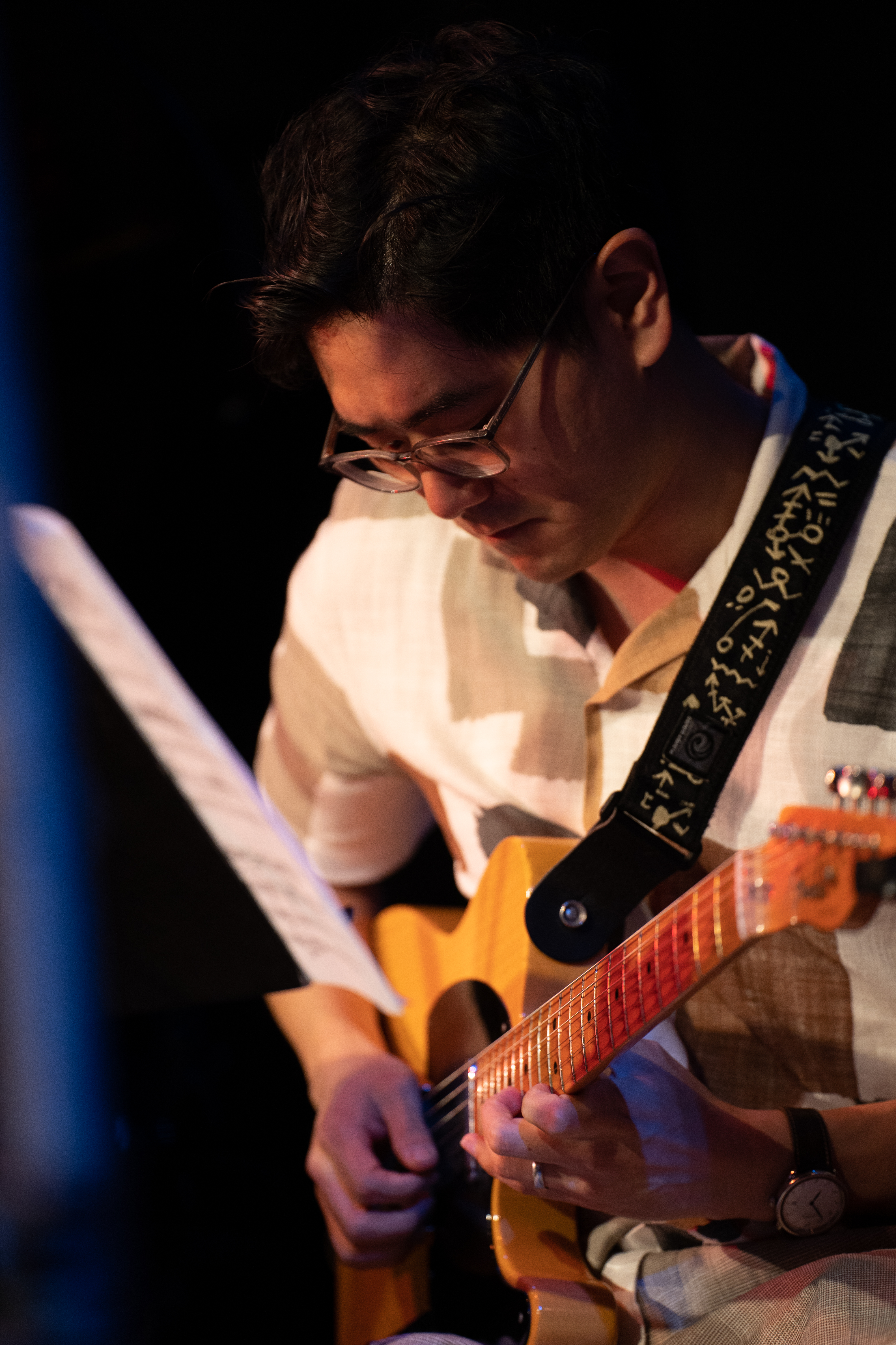 Tony Song reading charts and playing